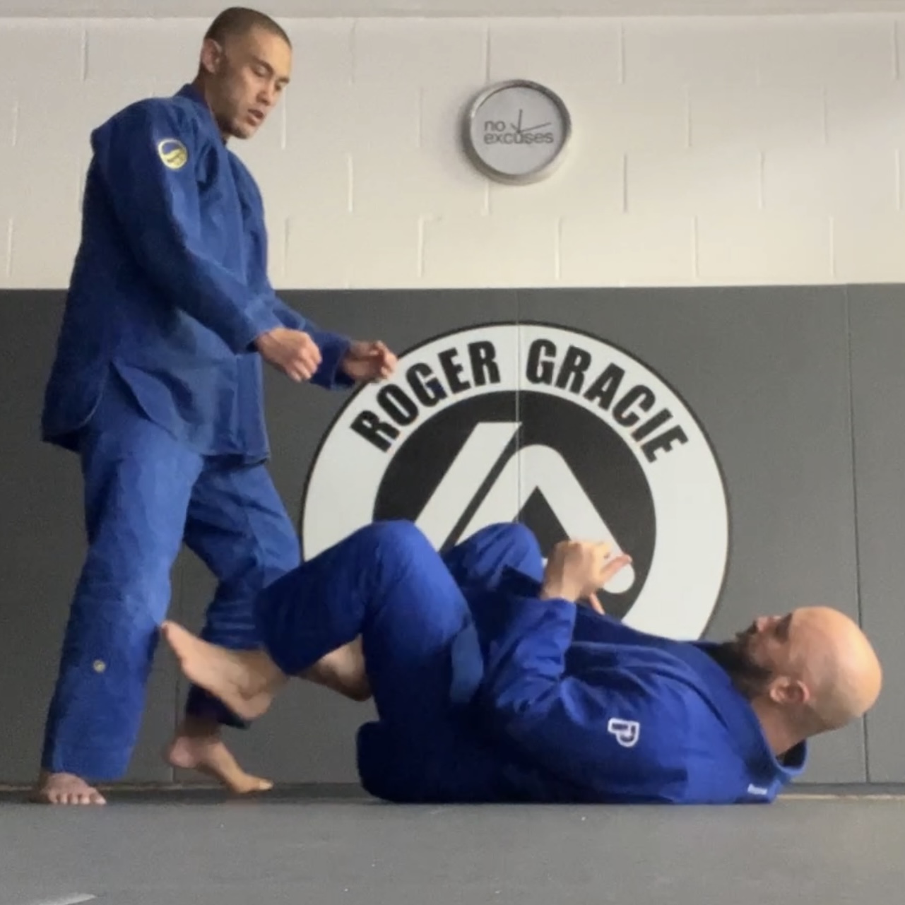 Olgun Tiltay learning ground grappling from Chris Ong [2nd Dan] BJJ Coach at Roger Gracie Academy